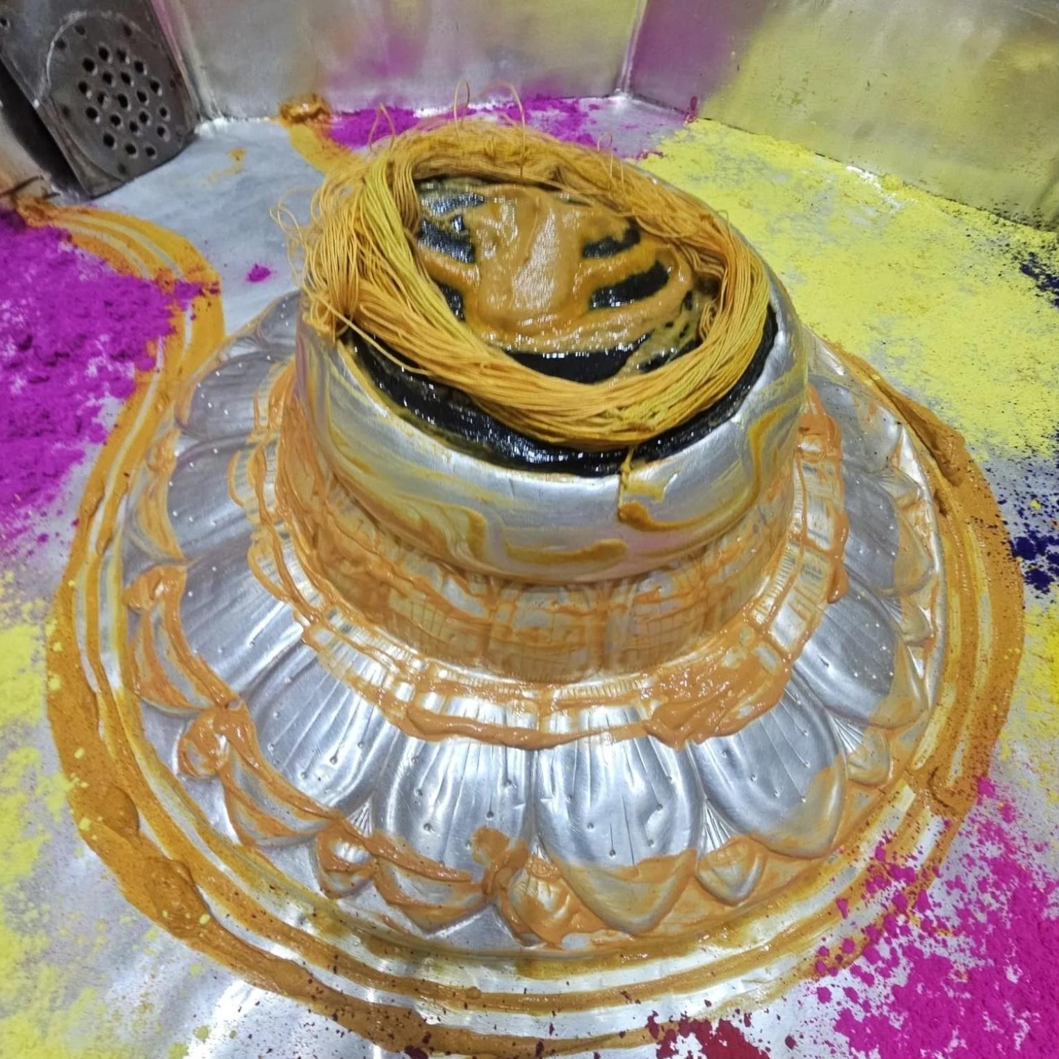 The Shivling at Baba Garibnath Dham adorned with chandan, sacred thread and coloured abir